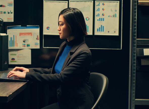 asian-private-inspector-examining-archived-materials-folder-scaled