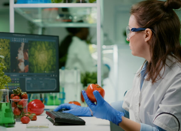 pharmaceutical-chemist-examining-tomato-microbiology-experiment-typing-medical-information-scaled